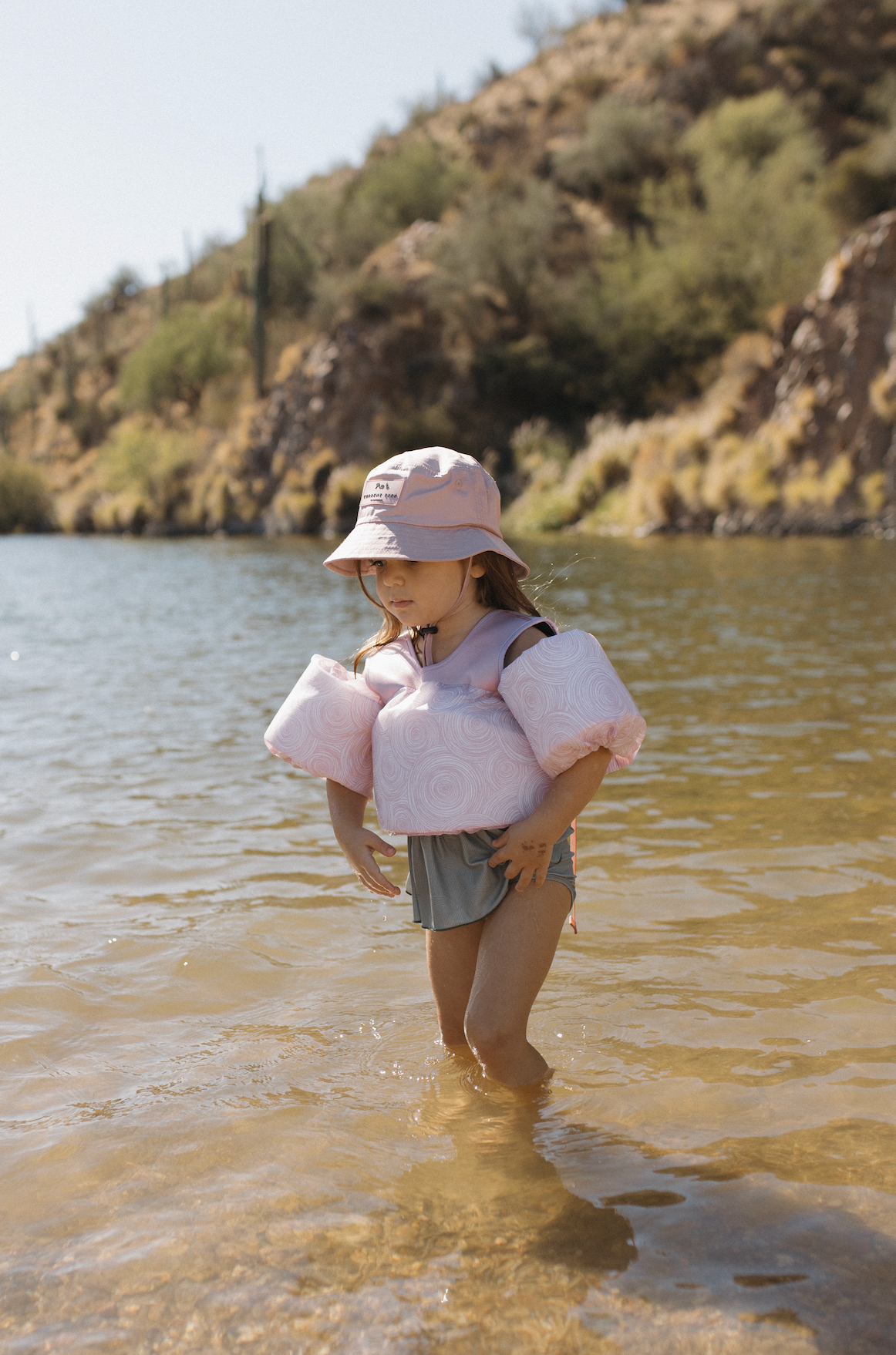 pink floaties and bucket hat